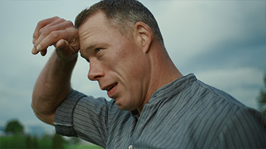 Still of the hüsler nest film showing Matthias sempach at work wiping the sweat off his brow.